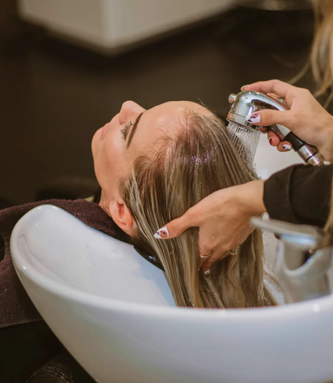 Haidresser washing hair