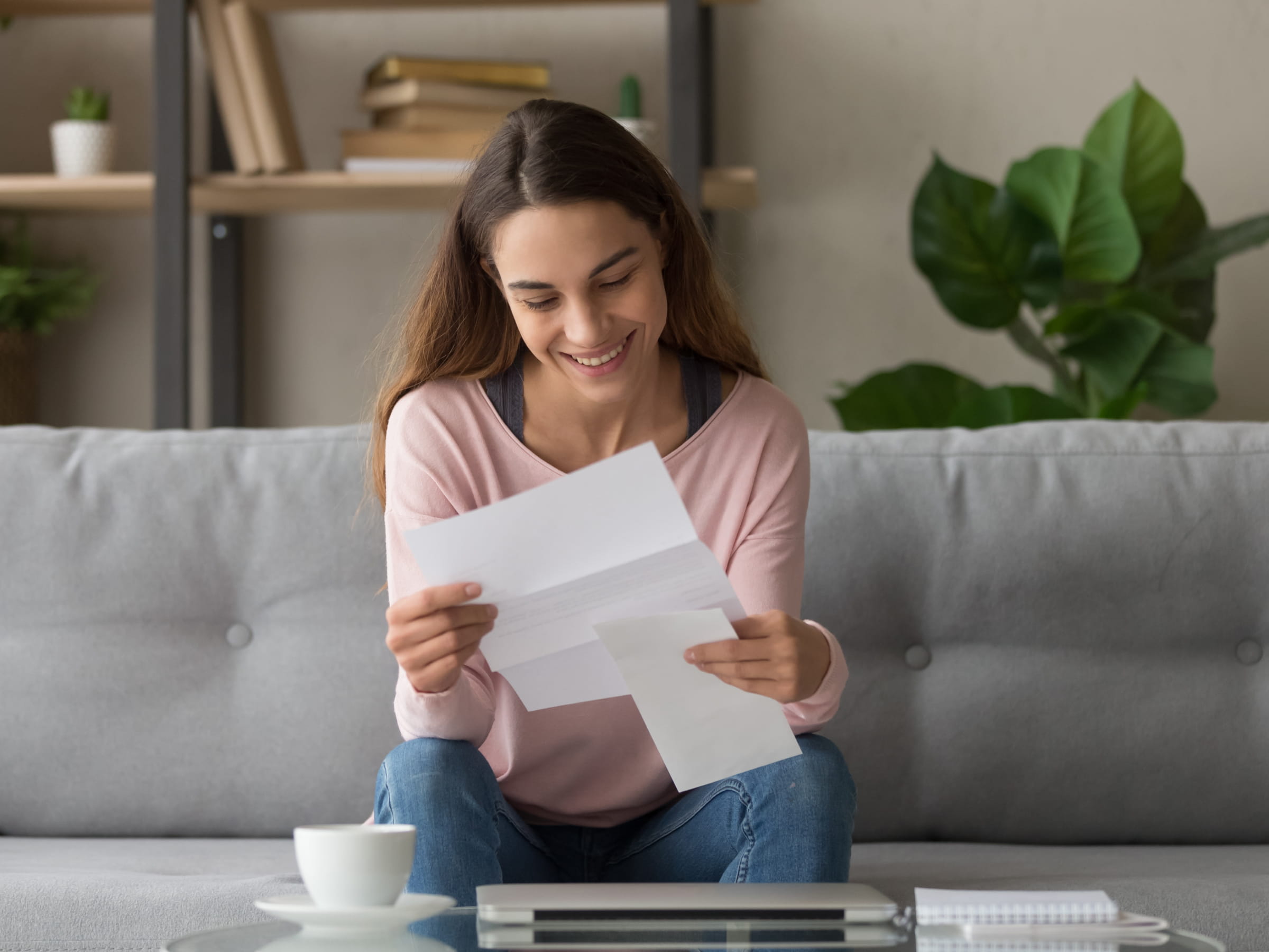 Women on sofa reading letter